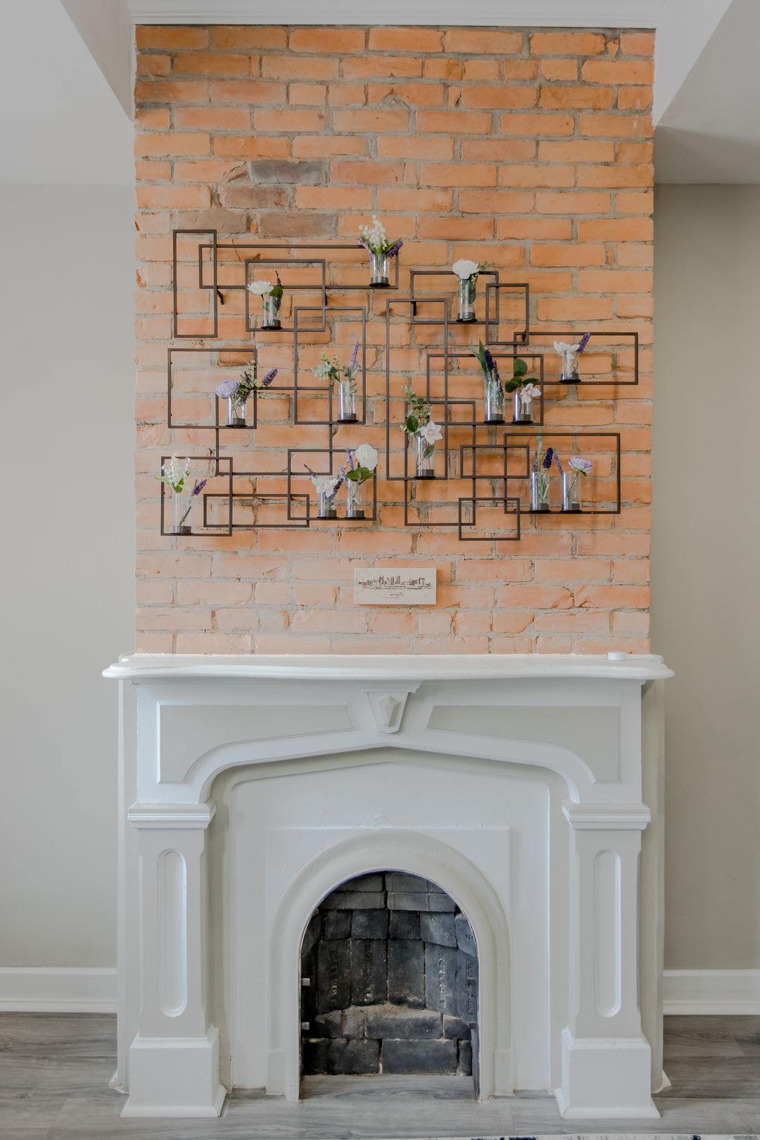 The living room's brick fireplace and accent wall