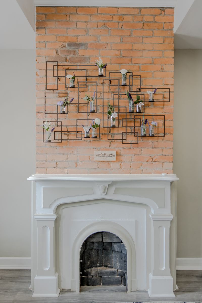 The living room's brick fireplace and accent wall