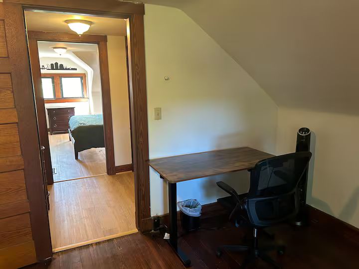 The fifth bedroom with a standing-desk workspace