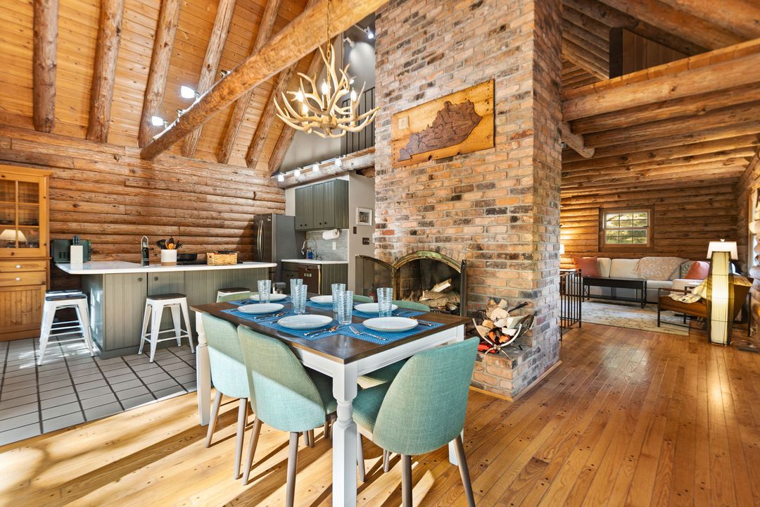 Open dining area beside the stone fireplace