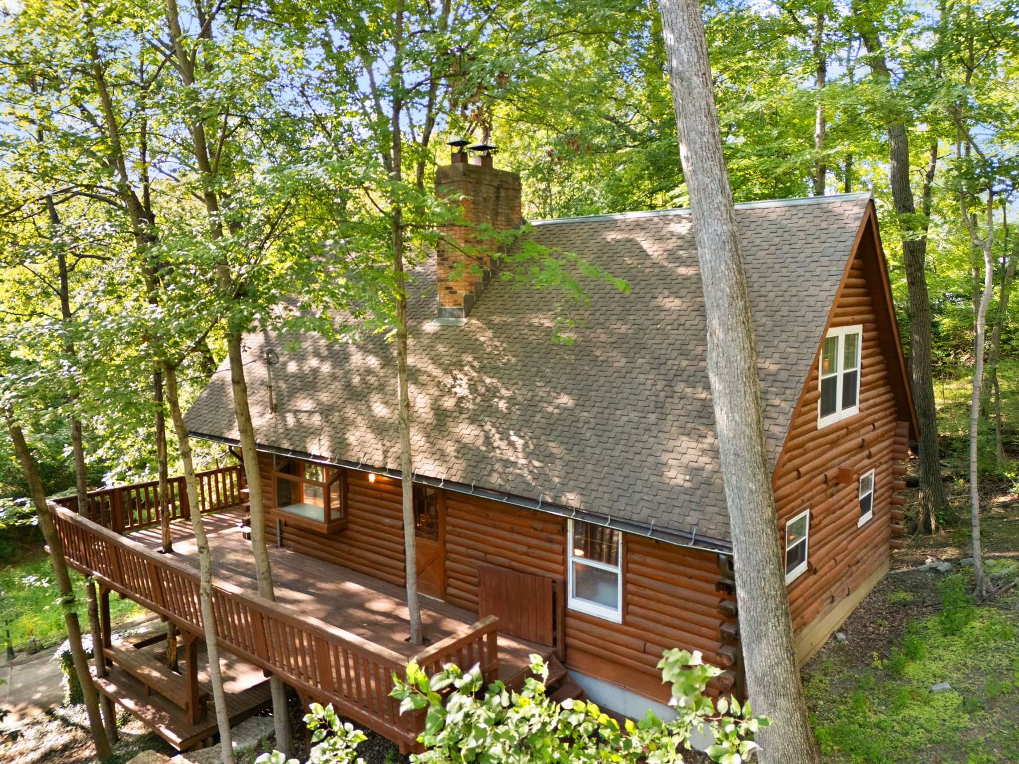 Aerial view of the cabin surrounded by woods