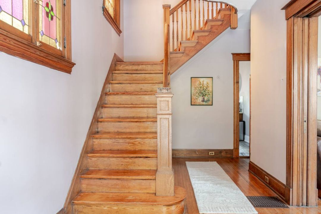 The original wood staircase in the entryway