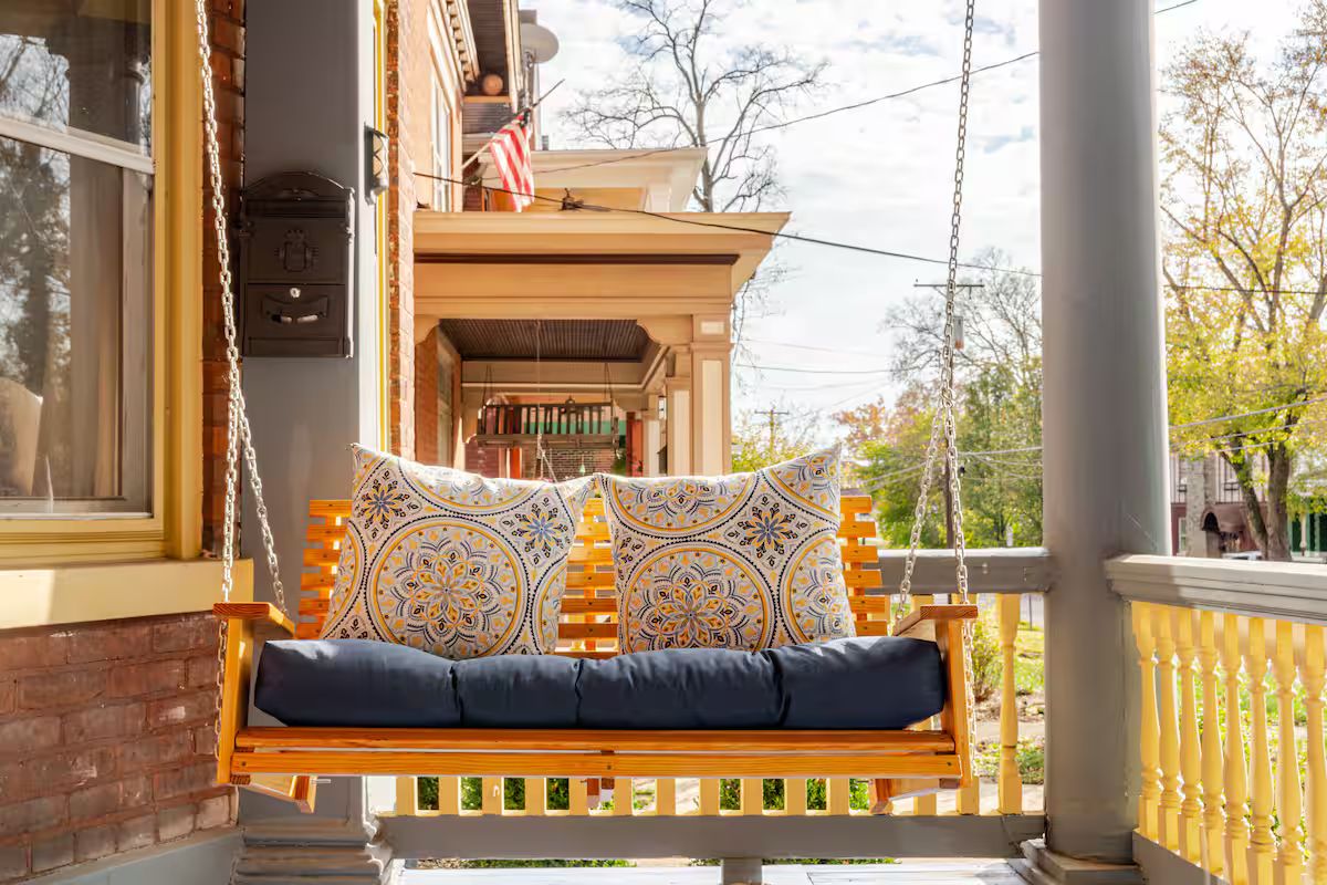 The welcoming front porch and swing of the historic Eastern Avenue home