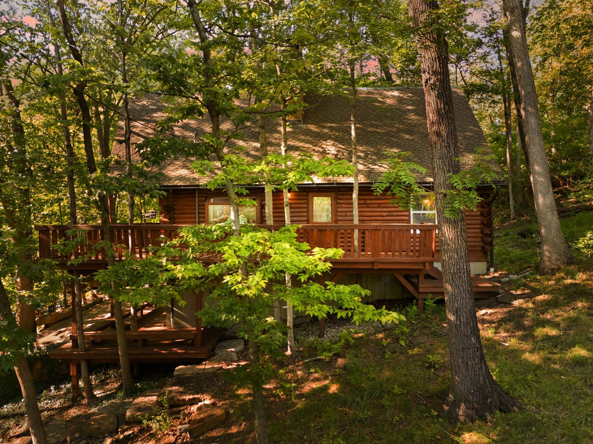 The Log Cabin's wood exterior framed by the trees