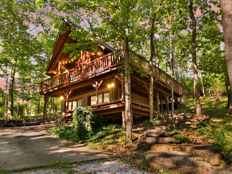 The Log Cabin glowing at golden hour among the trees