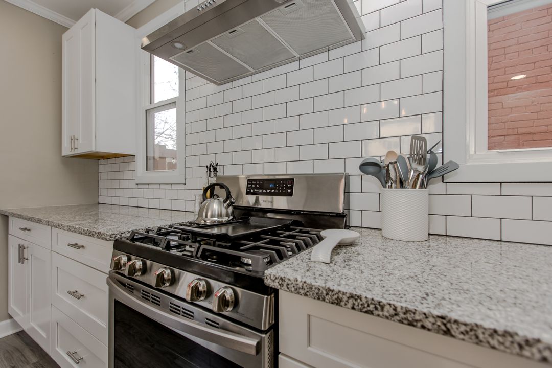 The gas range and subway-tile backsplash