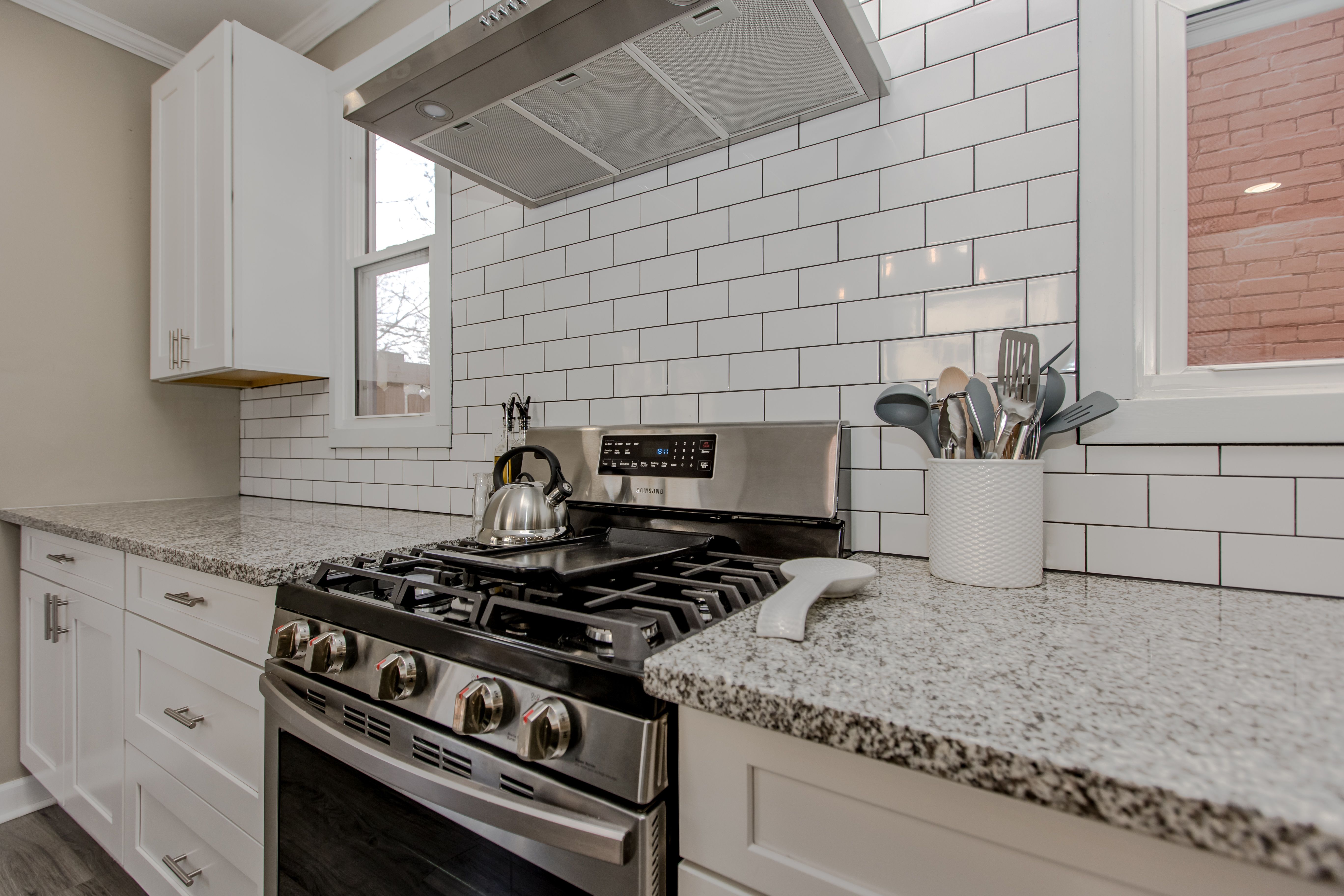 The gas range and subway-tile backsplash